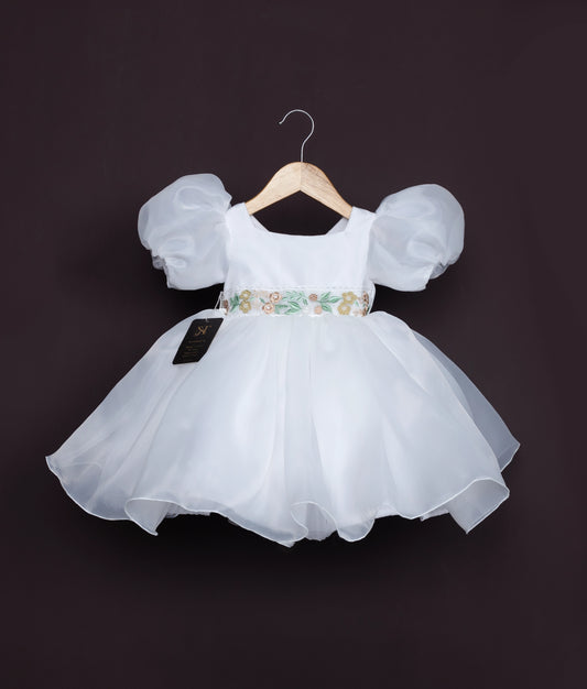 Off-white baby girl dress with puff sleeves and floral waistband—perfect for birthdays and special occasions