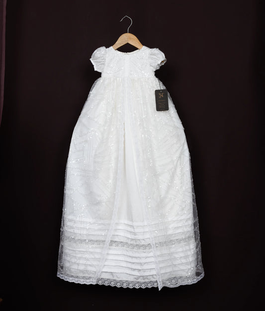 Off-white lace dress on a hanger against a dark background.