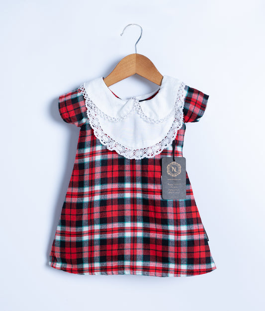 A red and black checkered cotton frock displayed on a hanger.
