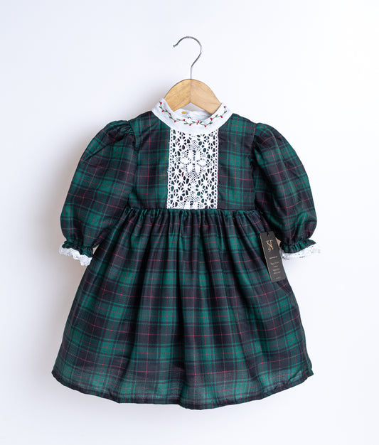 A black and green checkered cotton frock displayed on a hanger.