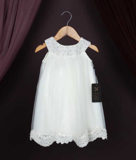 Off-white lace dress on a hanger against a dark background.