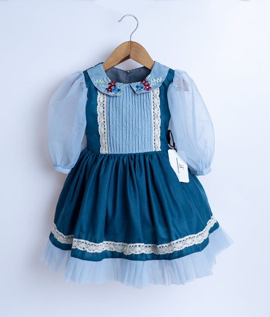 A blue floral embroidery cotton frock displayed on a hanger.
