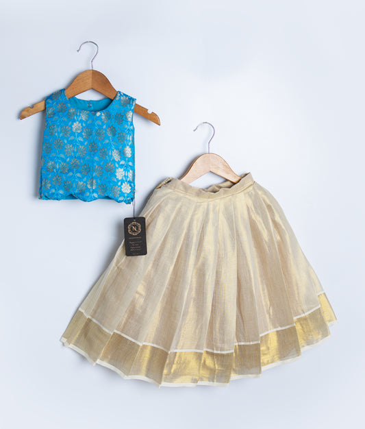 A kids ethnic wear set featuring a sleeveless blue brocade blouse with golden floral patterns and a gold flared skirt with sheer overlay, displayed on hangers.