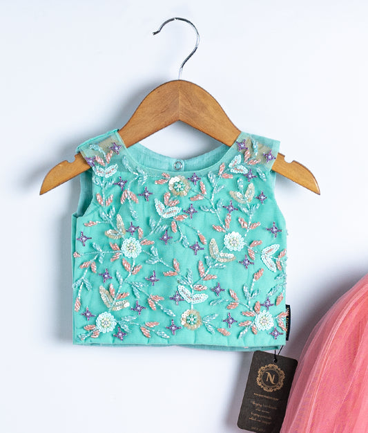 Close-up of aqua blue swan theme embroidered top showing handmade applique work in skirt and top set for baby girl
