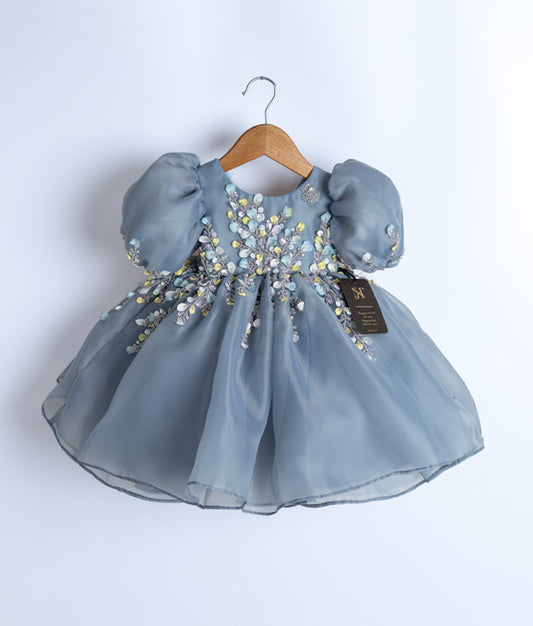 Front view of an ash-colored hand-worked organza flower theme dress for baby girls with a voluminous skirt