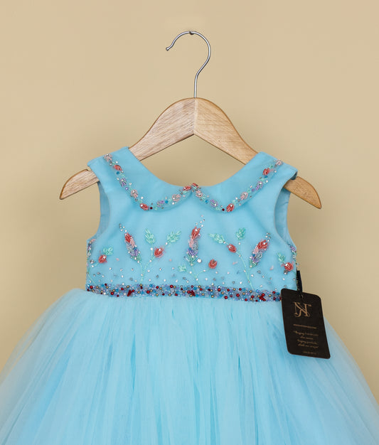 Front view of baby girl blue frock with decorative bodice and layered tulle skirt
