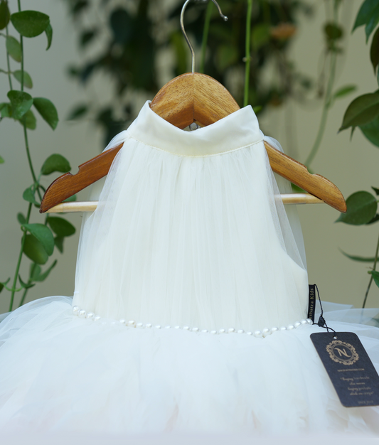 Front view of baby girl feather frock in white with pink feather trim and layered tutu skirt