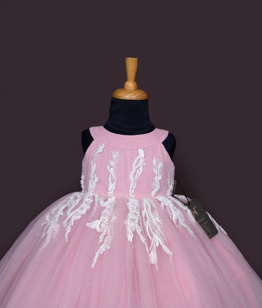 Front view of baby girl pink frock featuring white flower appliques and layered tulle skirt