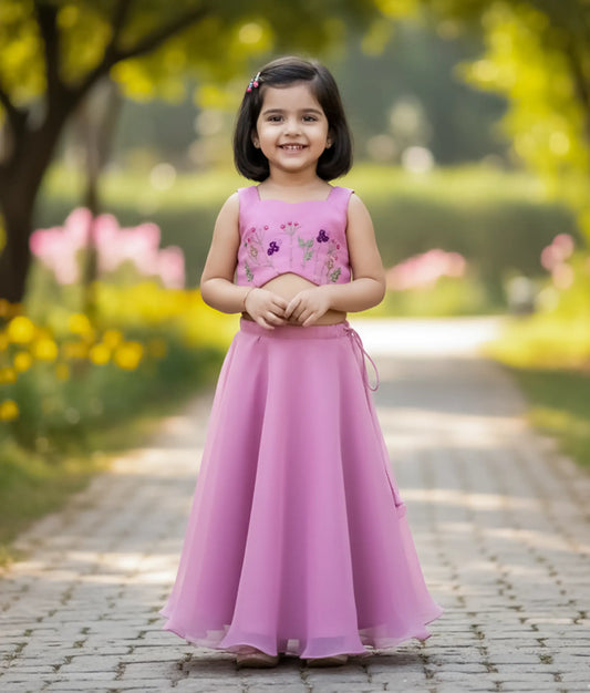 A baby girl wearing the pastel lavender handworked top and layered plain organza full-length skirt