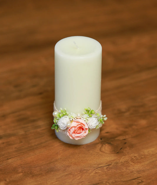 Close-up of the baptism candle showing the handmade peach rose, pearl accents, and white lace detailing