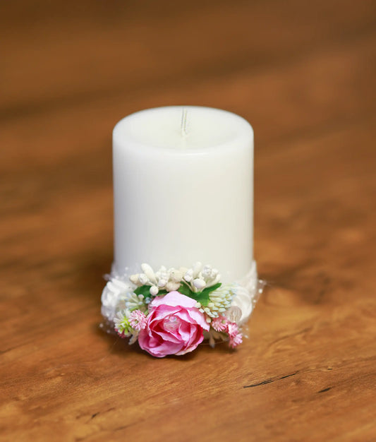 Close-up of the baptism candle showing the handmade pink rose, shimmering beads, and delicate white lace