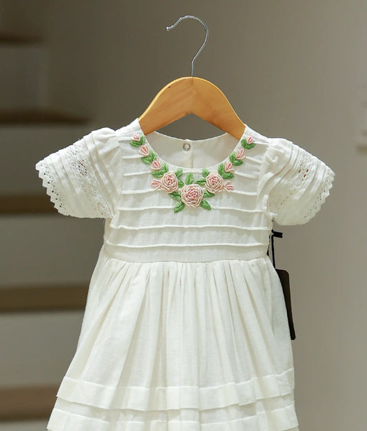 Close-up of the premium lace fabric and delicate embroidery on the baptism frock