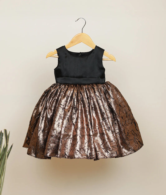 Front view of a black and gold shimmer crush organza frock for baby girls with a fitted bodice and flared skirt