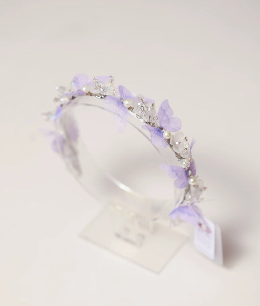 Close-up of the handcrafted tiara showing lavender butterflies, white pearls, and shimmering crystal beads