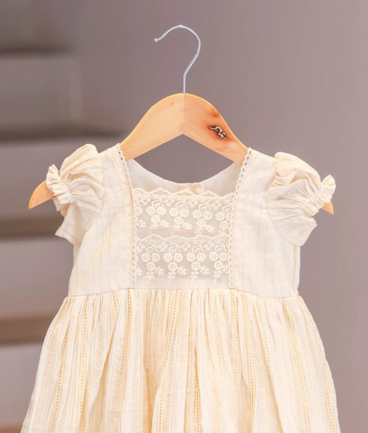 Close-up of the soft cotton fabric and vibrant floral print on the casual baby frock