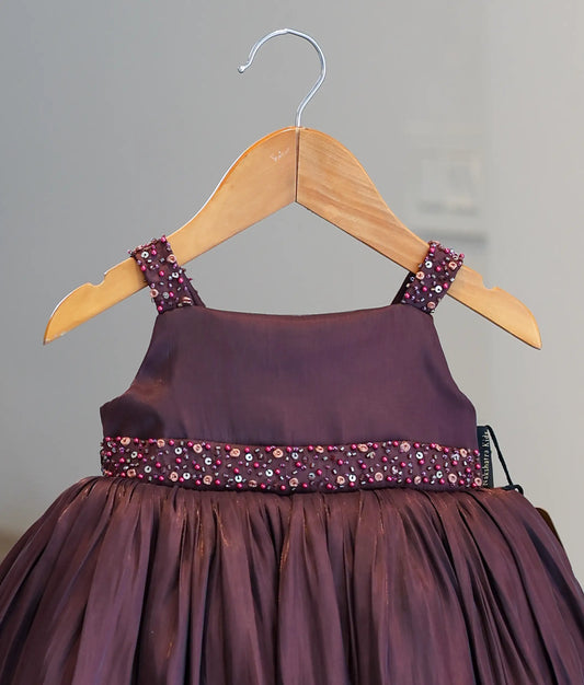 Close-up of the sequin and bead handwork on the shoulder straps and waist belt of the coffee brown organza frock.