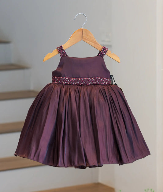 Front view of a coffee brown laser organza frock for girls with a handworked waist belt and crushed pleated flare.