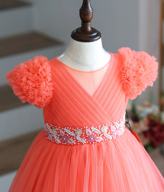 Close-up of the cut bead and pearl hand-work on the coral peach gown.