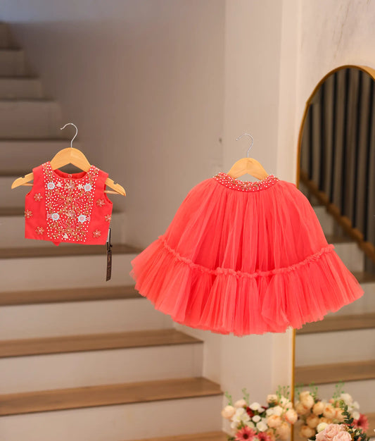 Front view of a dark pink handworked crop top and full-length layered tulle skirt for baby girls