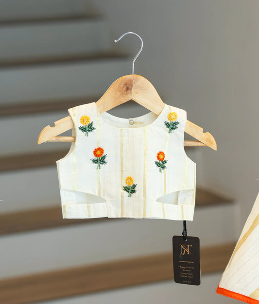 Close-up of the orange and yellow floral bead handwork on the striped top.