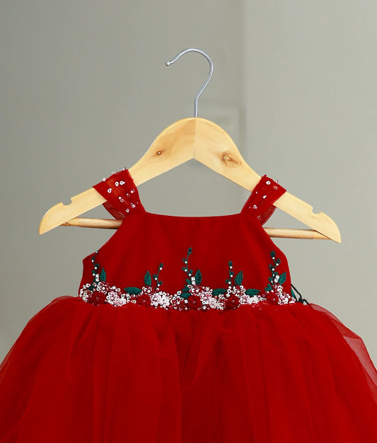 Close up of floral embroidery and pink sequins on the bodice of the red party wear frock.