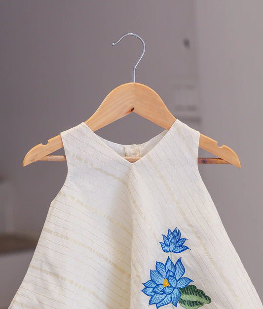 Close-up of the traditional frock showing the rich gold Kasavu border and soft Kerala cotton fabric