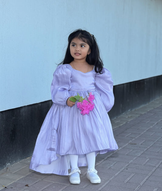 Front view of a pastel lavender laser organza high-low birthday frock for baby girls featuring long puff sleeves