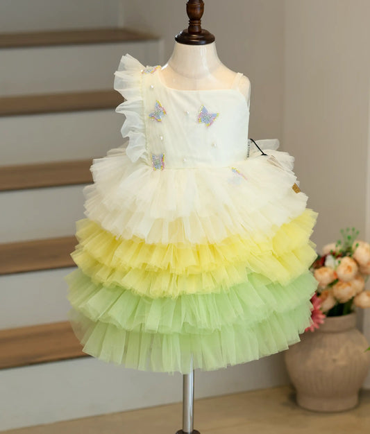 Front view of the multi-color butterfly-themed birthday frock featuring yellow-green soft tulle net and an asymmetric shoulder.