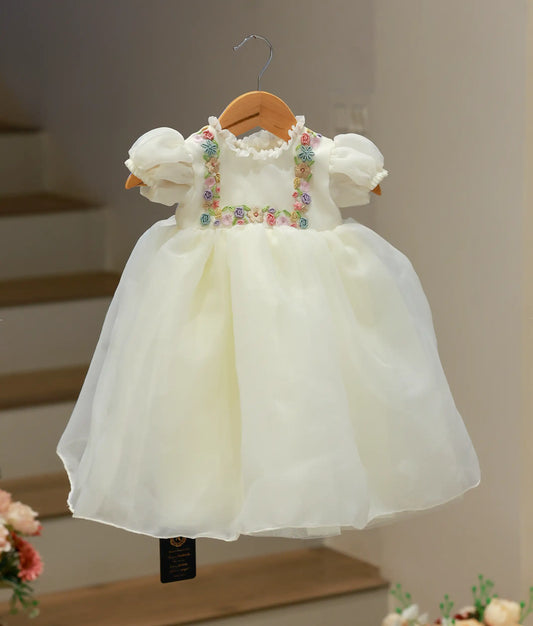 Full front view of an off-white baby girl baptism frock crafted from plain organza with delicate hand-worked embroidery on the bodice