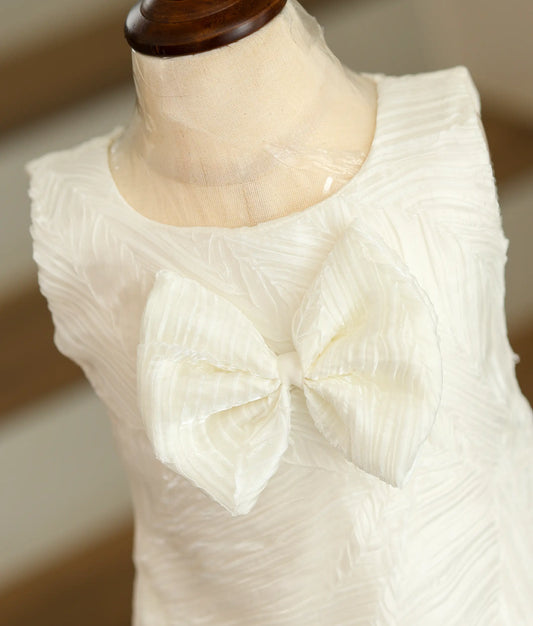 Close-up of the unique tuck organza fabric texture and the oversized front bow detailing.