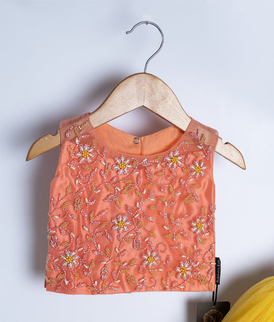 Close-up of orange floral embroidered baby dress top