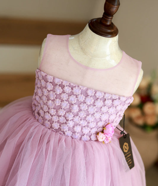 Close-up of the premium work material on the bodice and handmade flowers at the waist of the lavender frock.