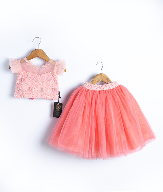 Peach pink toddler dress with lace top and tulle skirt on hangers