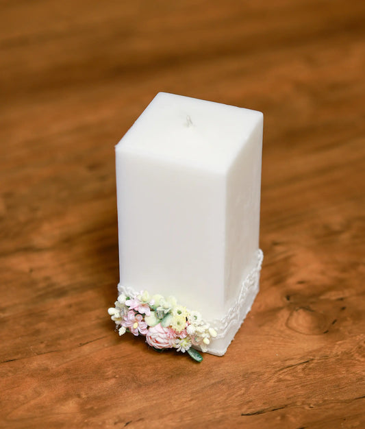 Close-up of the handcrafted pink roses and shimmering pearl accents on the decorative baptism candle