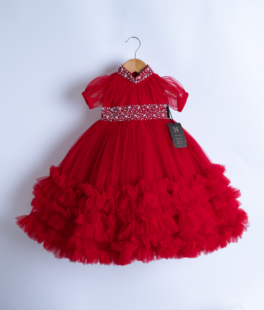 Front view of red baby girl party dress with beaded waist on hanger