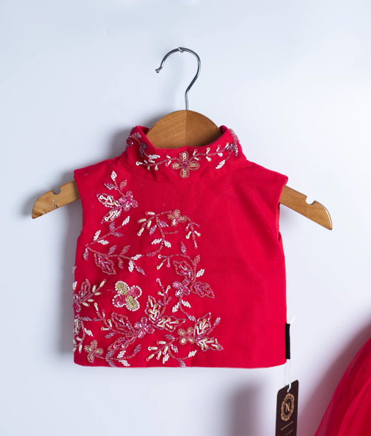 Close-up of red baby girl floral embroidered top – traditional festive wear for toddlers