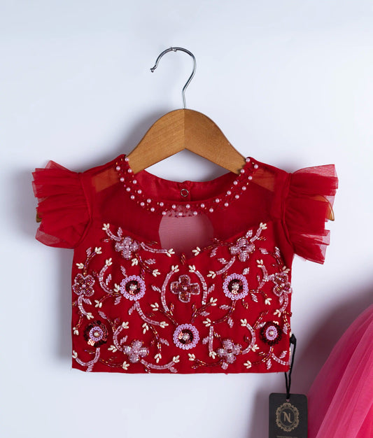 Close-up of red swan theme dress showing intricate handmade applique work and embroidery on bodice