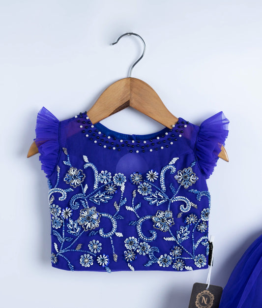 Close-up of royal blue baby girl top with detailed applique embroidery and flutter sleeves