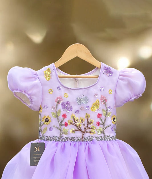 Side view of lavender toddler girl dress with puff sleeves and floral embroidery for parties and festive events