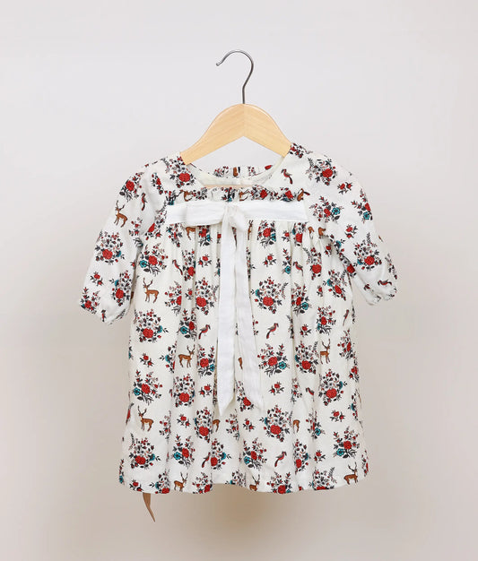 White floral printed cotton frock for baby girl, full front view showing flared skirt and puff sleeves.