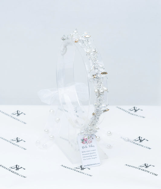 Front view of a luxe white hair crown for girls featuring pearls, crystals, and gold-toned floral embellishments