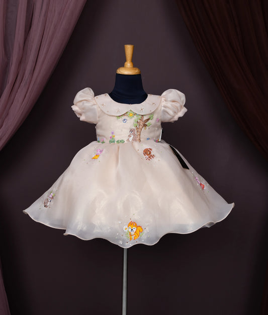 Beige baby girl dress with puff sleeves, Peter Pan collar, and cartoon forest animal embroidery.
