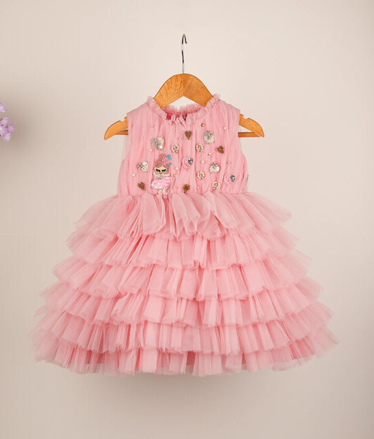 Front view of pink fairy-themed step birthday dress against plain background