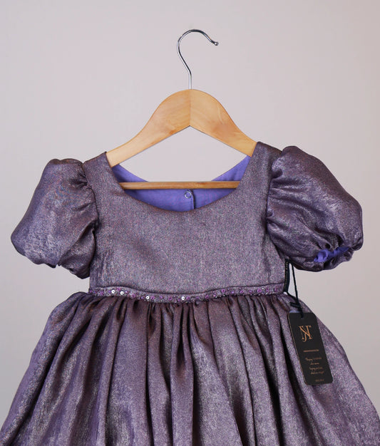 Close view of an handworked milan foil frock against white background