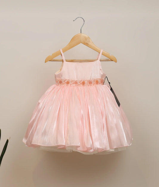 Front view of pink lacer organza handworked birthday frock against plain background