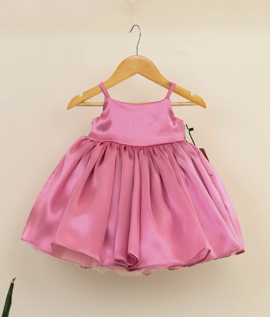 Front view of an rafaella pink cute birthday frock against plain background