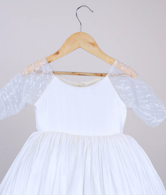 Close view of an off-white lacer organza flower girl dress with medium work-material sleeves