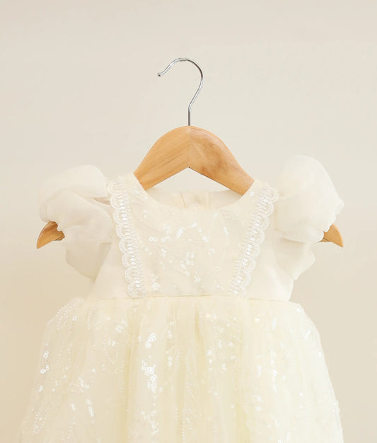Close view of off-white plain organza work material baptism gown