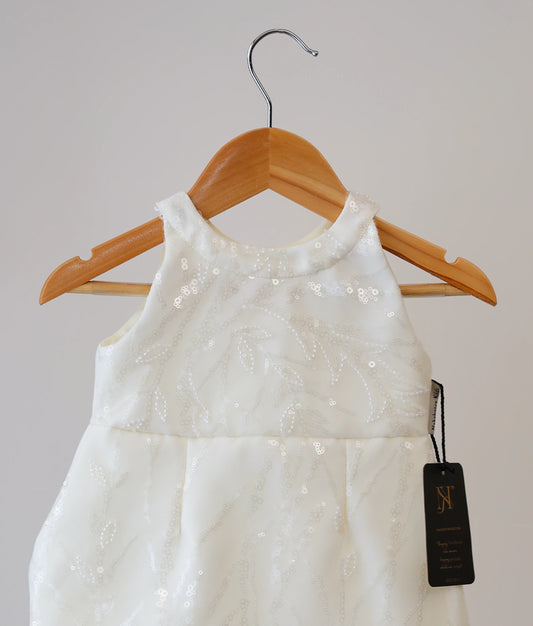 Front view of an off-white work material fish-cut baptism frock against plain background