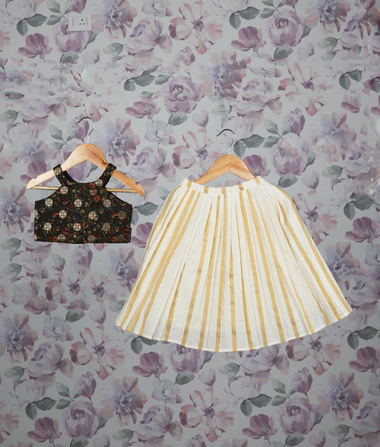 Floral green crop top and golden striped pleated skirt set against a floral background.